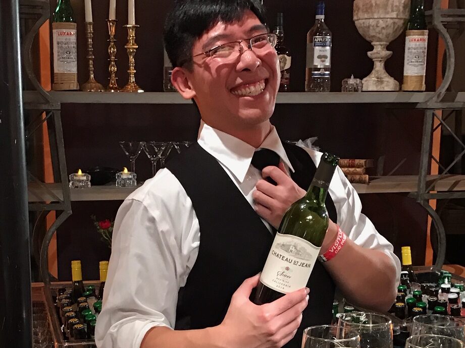 man opening wine bottle